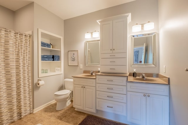 bathroom featuring toilet, tile patterned floors, double vanity, and a sink