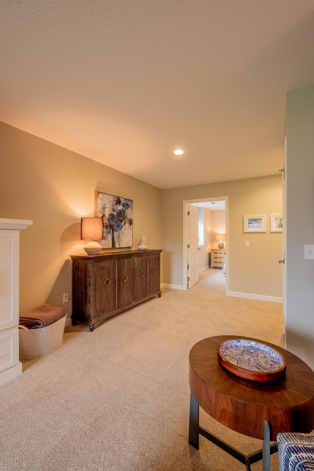 living area featuring baseboards, recessed lighting, and carpet