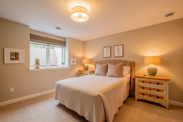 bedroom with carpet floors, baseboards, and visible vents