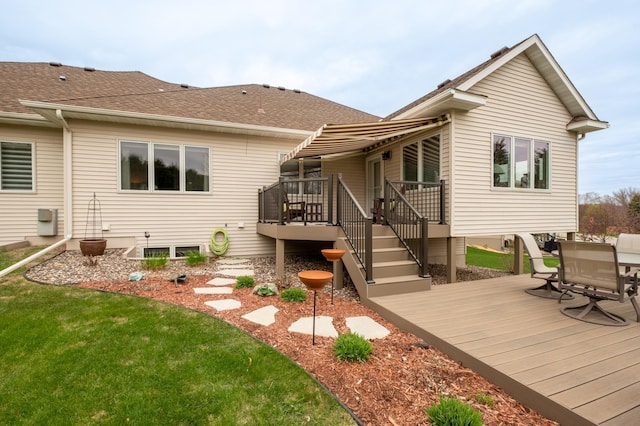 back of house featuring a shingled roof, a yard, stairway, and a deck
