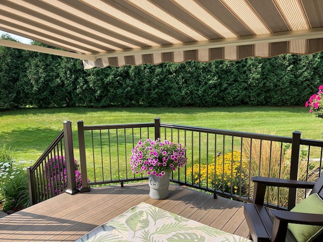 wooden deck with a lawn