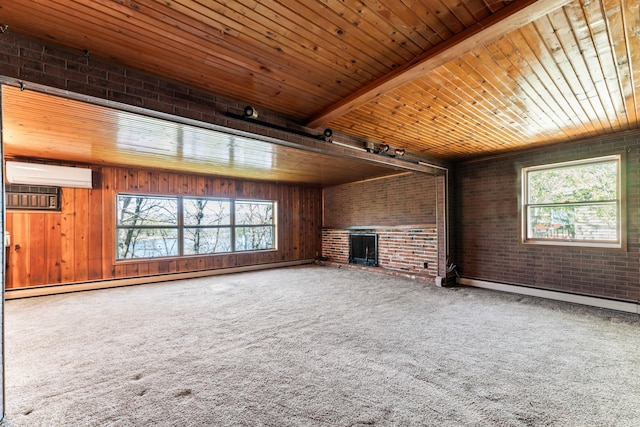 unfurnished living room with brick wall, a wall mounted AC, a healthy amount of sunlight, and a baseboard heating unit