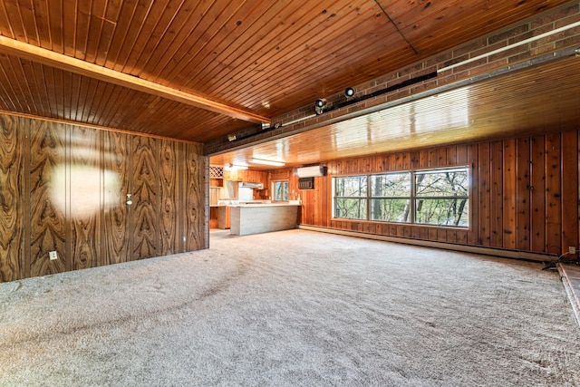 unfurnished living room featuring carpet flooring, wooden walls, wooden ceiling, and an AC wall unit