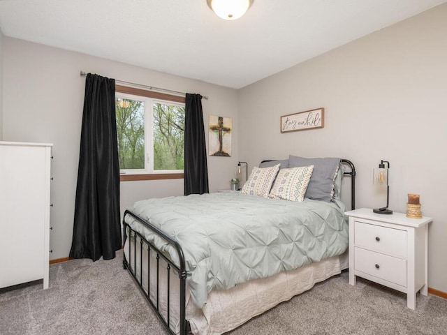 bedroom featuring baseboards and light carpet