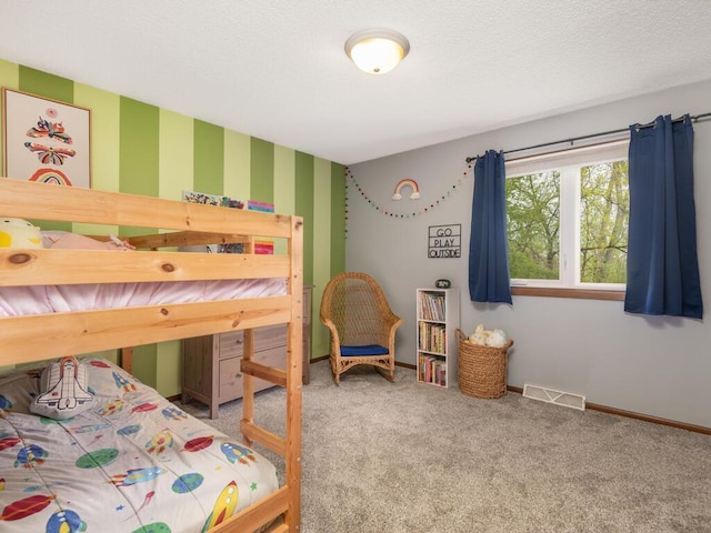 bedroom with visible vents, carpet, baseboards, and wallpapered walls