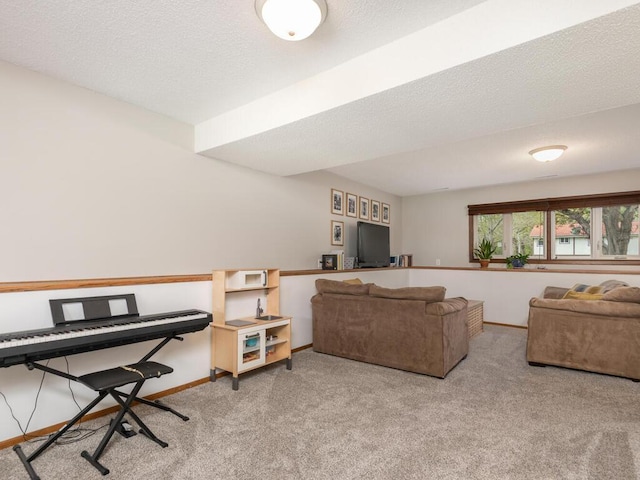carpeted living area featuring baseboards