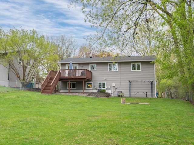 rear view of property with stairs, a fenced backyard, a wooden deck, and a yard