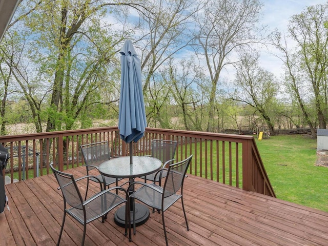 wooden terrace featuring a yard and outdoor dining space