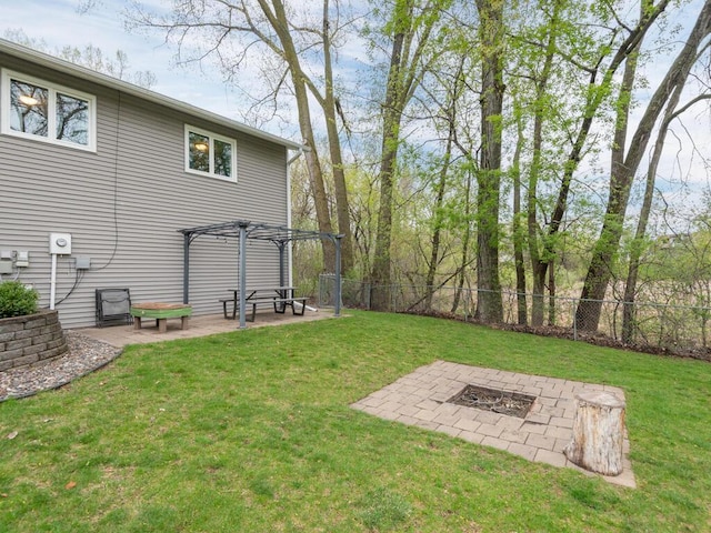 view of yard featuring a patio, a fire pit, fence, and a pergola