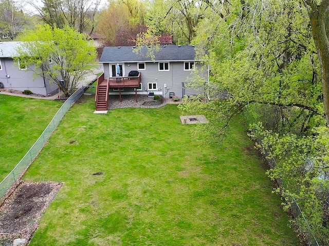 back of property with fence, a yard, stairway, and a deck