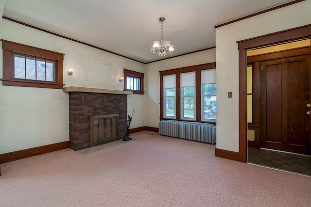 165 Park Ave, Le Center, MN 56057 - unfurnished living room with radiator heating unit, a fireplace, a chandelier, carpet floors, and crown molding