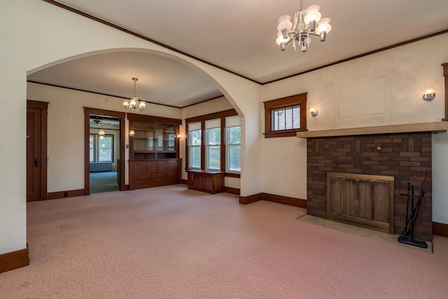 165 Park Ave, Le Center, MN 56057 - unfurnished living room featuring a chandelier, carpet flooring, arched walkways, and ornamental molding