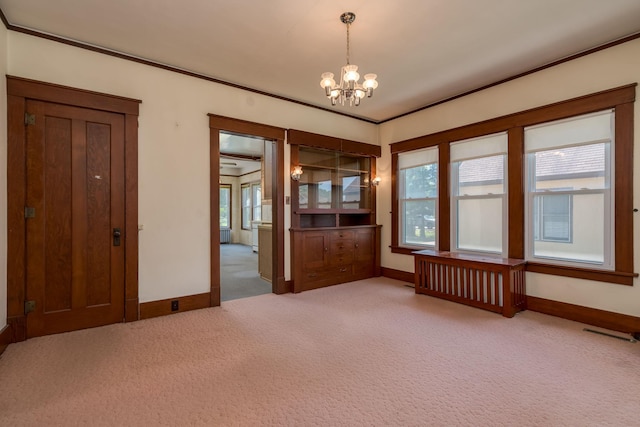 165 Park Ave, Le Center, MN 56057 - empty room featuring carpet flooring, a chandelier, plenty of natural light, and crown molding