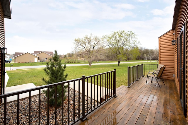 wooden deck featuring a yard