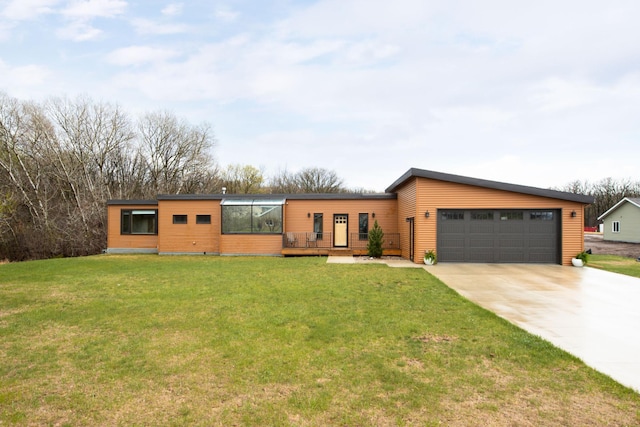 view of front of home with a garage, a front yard, and concrete driveway