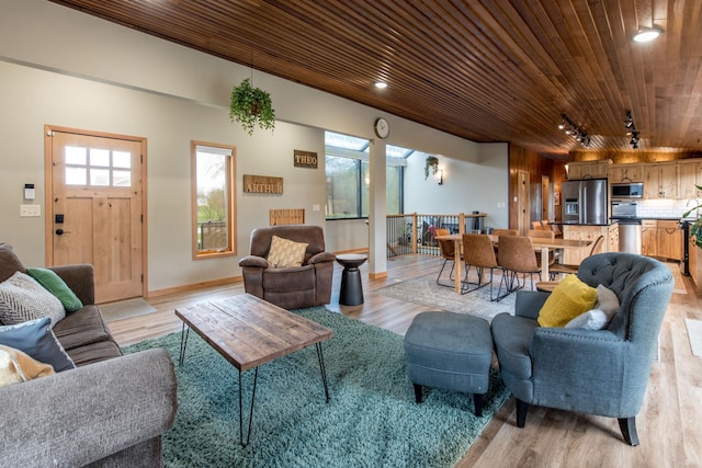 living area with baseboards, recessed lighting, wood ceiling, and light wood finished floors