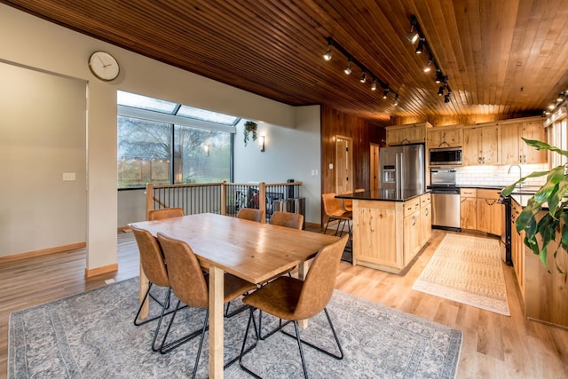 dining area featuring track lighting, light wood-style floors, baseboards, and wooden ceiling