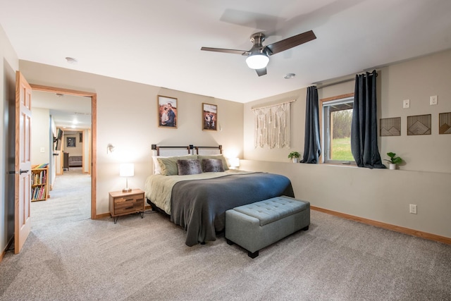 carpeted bedroom featuring baseboards and ceiling fan