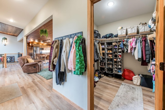 walk in closet with wood finished floors