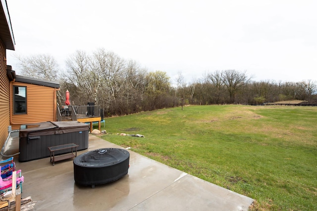 view of yard with a hot tub, a patio, and an outdoor fire pit