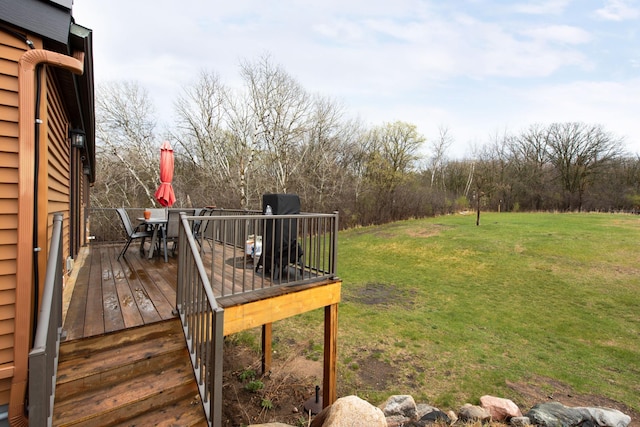 wooden terrace featuring a yard, outdoor dining area, and area for grilling