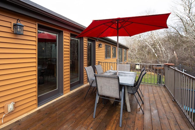 wooden terrace with outdoor dining space
