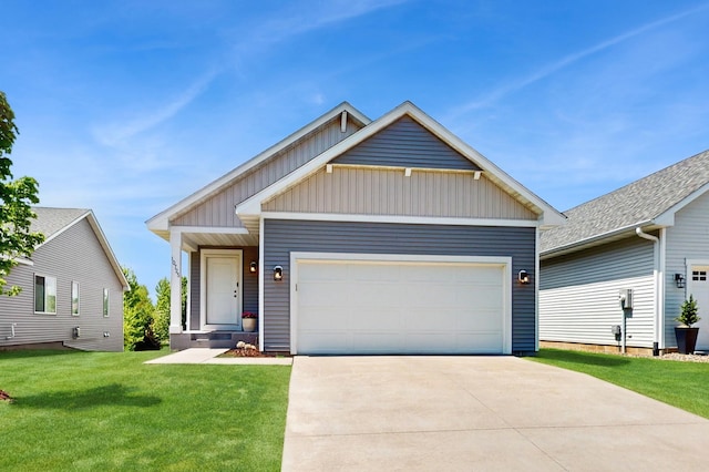 10725 Knollwood Ln, Woodbury, MN 55129 - view of front of house featuring board and batten siding, a front yard, a garage, and driveway