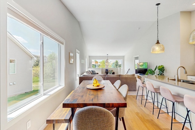 10725 Knollwood Ln, Woodbury, MN 55129 - dining area with light wood-type flooring and vaulted ceiling