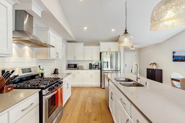10725 Knollwood Ln, Woodbury, MN 55129 - kitchen with appliances with stainless steel finishes, wall chimney exhaust hood, a sink, recessed lighting, and backsplash