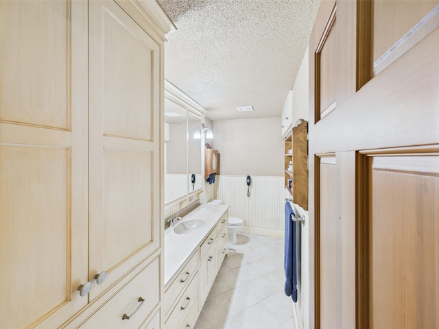 28656 195th Ave, Avon, MN 56310 - bathroom with toilet, a wainscoted wall, vanity, and a textured ceiling