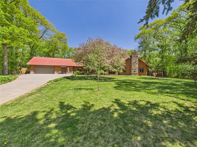 28656 195th Ave, Avon, MN 56310 - view of front of home featuring an attached garage, concrete driveway, a front yard, stone siding, and a chimney