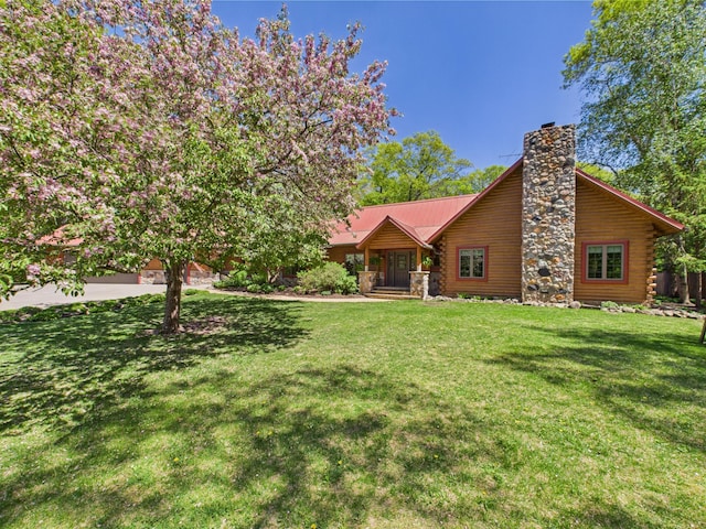 28656 195th Ave, Avon, MN 56310 - view of front of home featuring a chimney, a front yard, log exterior, and metal roof