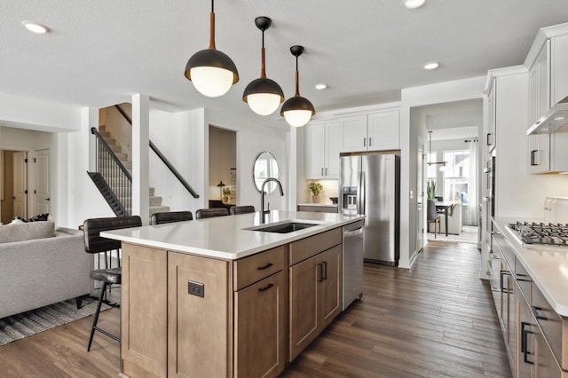 14580 106th Pl N, Maple Grove, MN 55369 - kitchen with a sink, light countertops, stainless steel appliances, open floor plan, and a kitchen bar