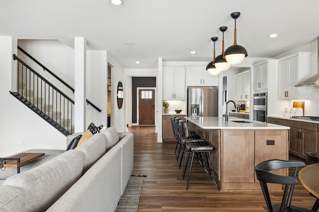 14580 106th Pl N, Maple Grove, MN 55369 - kitchen with appliances with stainless steel finishes, light countertops, a kitchen breakfast bar, open floor plan, and dark wood-type flooring