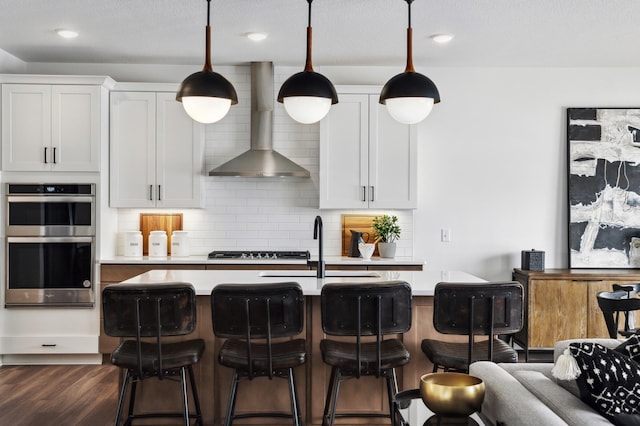 14580 106th Pl N, Maple Grove, MN 55369 - kitchen with light countertops, backsplash, stainless steel double oven, and wall chimney exhaust hood