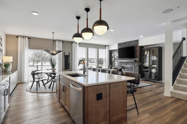 14580 106th Pl N, Maple Grove, MN 55369 - kitchen with a stone fireplace, dishwasher, a sink, light countertops, and open floor plan