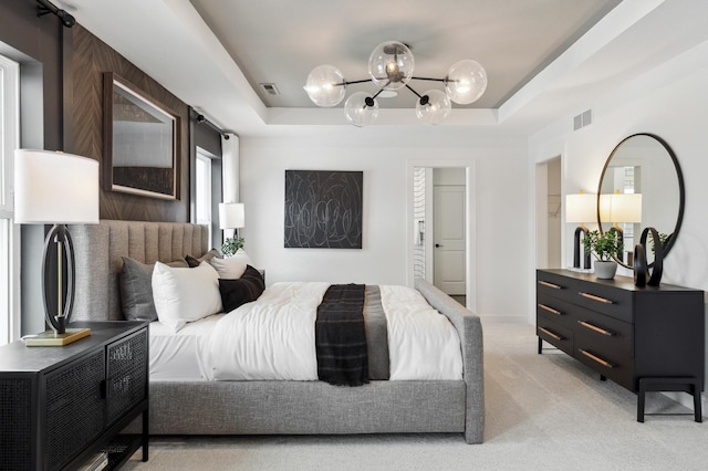 14580 106th Pl N, Maple Grove, MN 55369 - bedroom with an inviting chandelier, light carpet, a tray ceiling, and visible vents