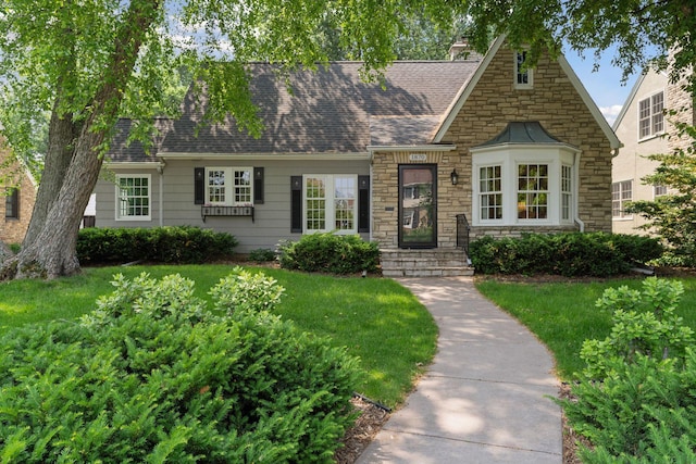 1870 Eleanor Ave, Saint Paul, MN 55116 - tudor home with stone siding, a front lawn, and a shingled roof
