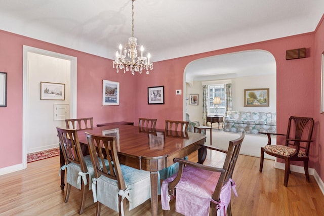 1870 Eleanor Ave, Saint Paul, MN 55116 - dining area with arched walkways, light wood-type flooring, and a chandelier