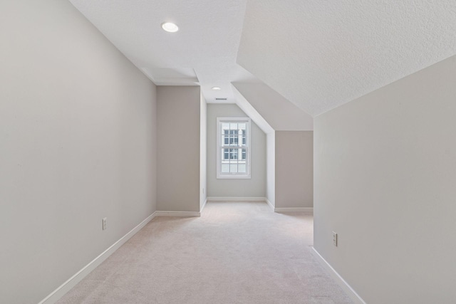 1870 Eleanor Ave, Saint Paul, MN 55116 - additional living space featuring light carpet, vaulted ceiling, recessed lighting, and a textured ceiling