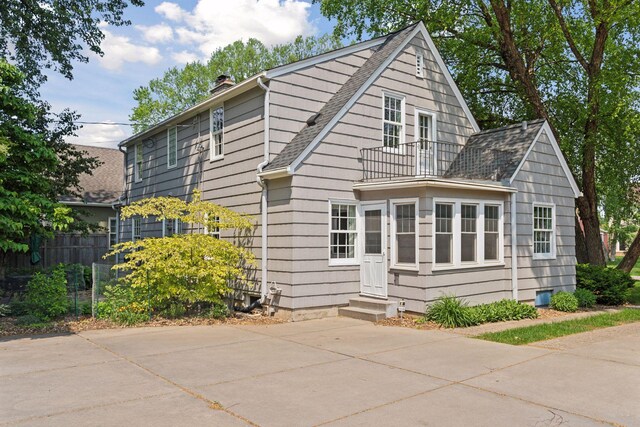 1870 Eleanor Ave, Saint Paul, MN 55116 - view of front of house featuring entry steps, a chimney, a shingled roof, and a balcony