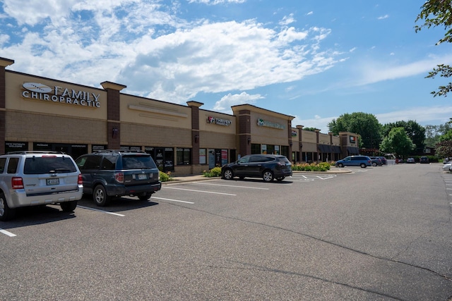 view of building exterior with uncovered parking
