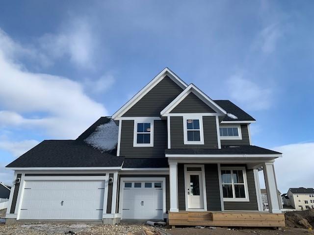 10451 Blackmoor Rd, Woodbury, MN 55129 - view of front facade with a porch, a garage, and driveway