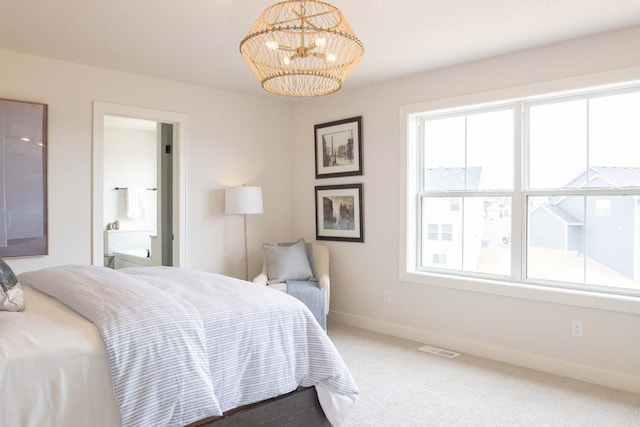 10451 Blackmoor Rd, Woodbury, MN 55129 - carpeted bedroom featuring baseboards, a notable chandelier, visible vents, and ensuite bath