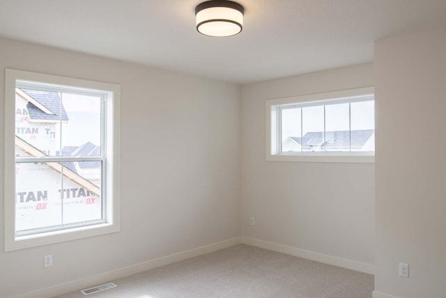 10451 Blackmoor Rd, Woodbury, MN 55129 - carpeted empty room featuring visible vents and baseboards