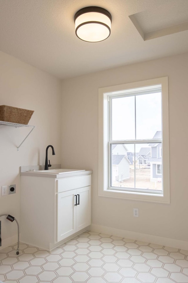 10451 Blackmoor Rd, Woodbury, MN 55129 - washroom with laundry area, a sink, plenty of natural light, and hookup for an electric dryer