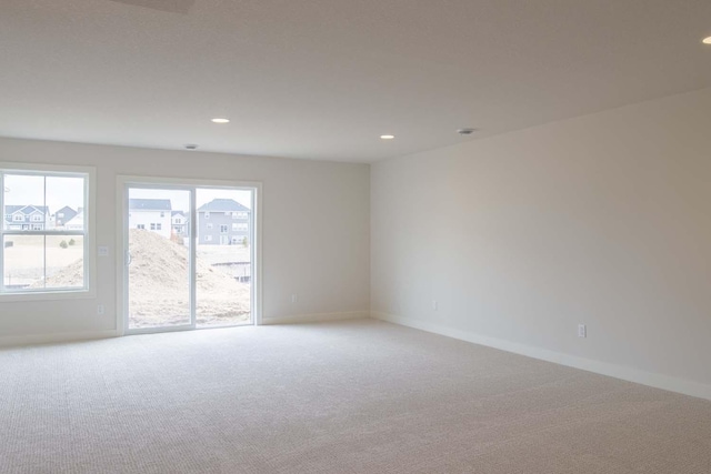 10451 Blackmoor Rd, Woodbury, MN 55129 - spare room featuring baseboards, recessed lighting, and light colored carpet