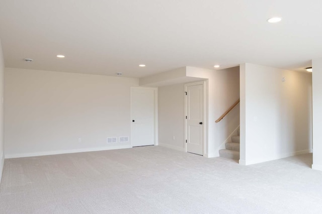10451 Blackmoor Rd, Woodbury, MN 55129 - unfurnished room with light carpet, stairs, recessed lighting, baseboards, and visible vents