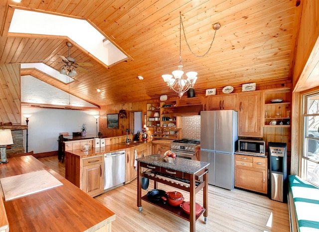 6575 145th St E, Cannon City Twp, MN 55057 - kitchen featuring a peninsula, a sink, open shelves, appliances with stainless steel finishes, and lofted ceiling