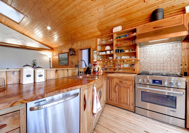 6575 145th St E, Cannon City Twp, MN 55057 - kitchen with butcher block countertops, a sink, stainless steel appliances, decorative backsplash, and lofted ceiling with skylight